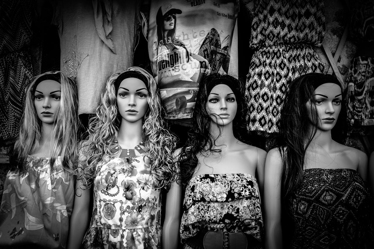 The Art of Drawing Readers In: Your attractive post title goes here Stylish black and white display of mannequins wearing varied fashion dresses.